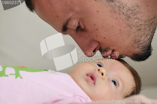 Image of indoor portrait with happy young famil and  cute little babby 