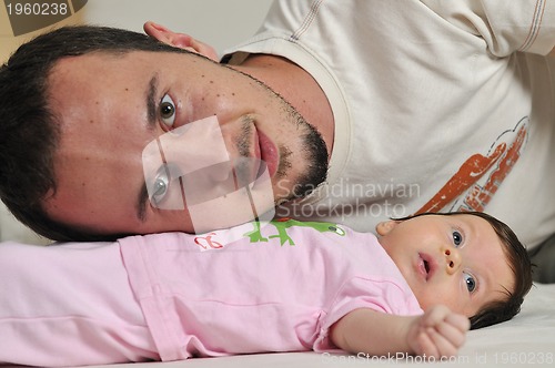 Image of indoor portrait with happy young famil and  cute little babby 