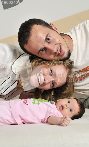 Image of indoor portrait with happy young famil and  cute little babby 
