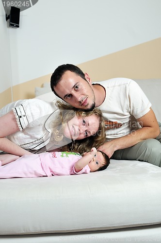 Image of indoor portrait with happy young famil and  cute little babby 