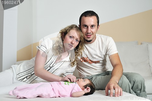 Image of indoor portrait with happy young famil and  cute little babby 