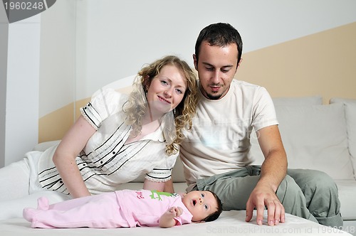 Image of indoor portrait with happy young famil and  cute little babby 