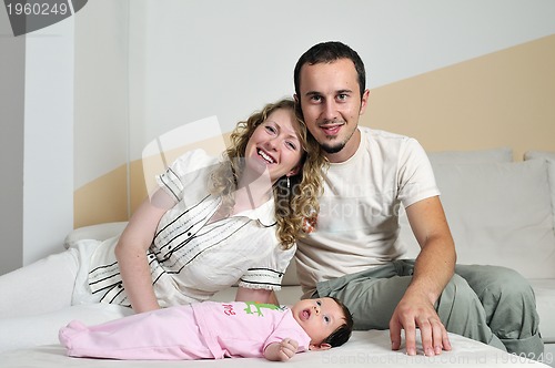 Image of indoor portrait with happy young famil and  cute little babby 