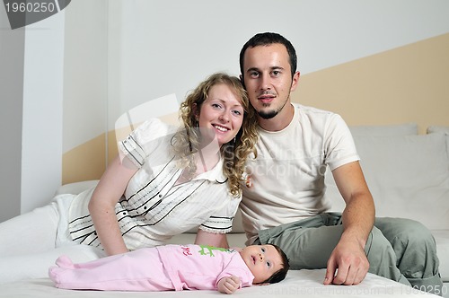 Image of indoor portrait with happy young famil and  cute little babby 