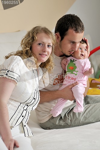 Image of indoor portrait with happy young famil and  cute little babby 