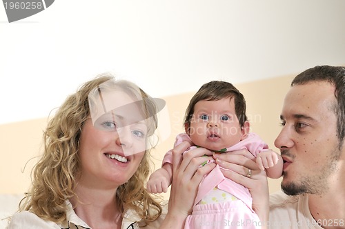 Image of indoor portrait with happy young family and  cute little babby 