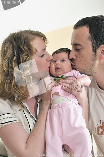 Image of indoor portrait with happy young family and  cute little babby 