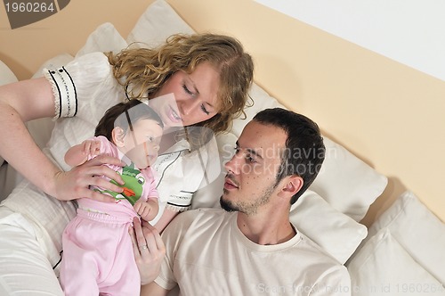 Image of indoor portrait with happy young family and  cute little babby 