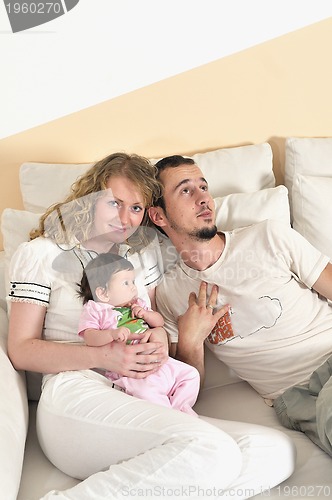 Image of indoor portrait with happy young family and  cute little babby 