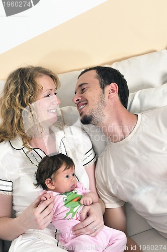 Image of indoor portrait with happy young family and  cute little babby 