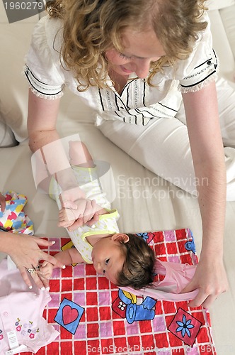 Image of beautiful young mother small with little baby