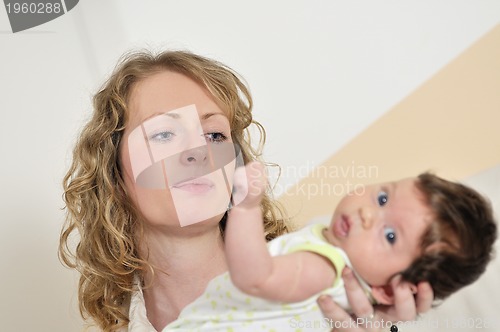 Image of beautiful young mother small with little baby