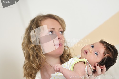 Image of beautiful young mother small with little baby