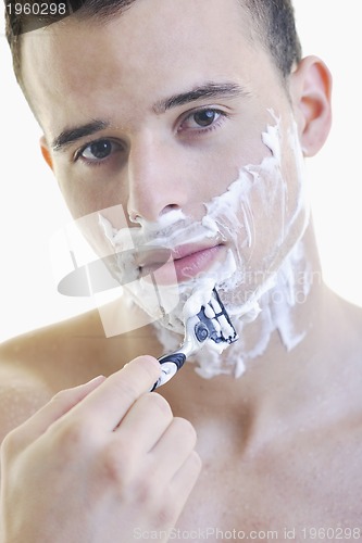 Image of young man shaving