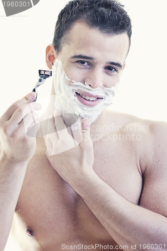 Image of young man shaving