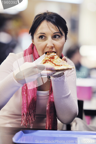 Image of woman eat pizza food at restaurant