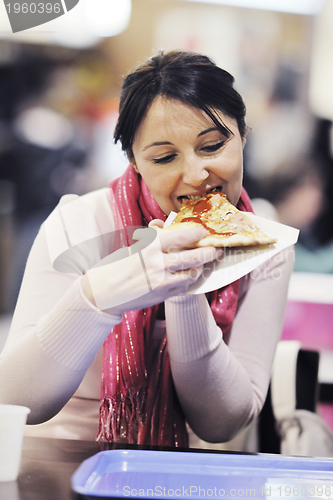 Image of woman eat pizza food at restaurant