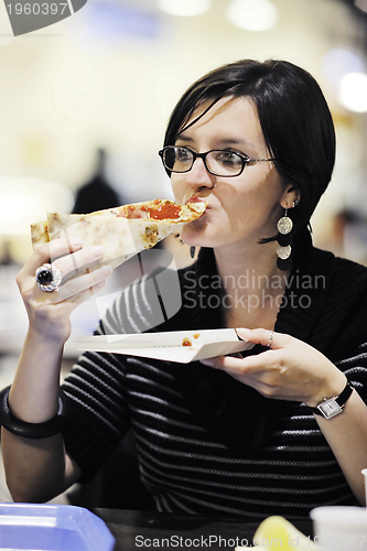 Image of woman eat pizza food at restaurant