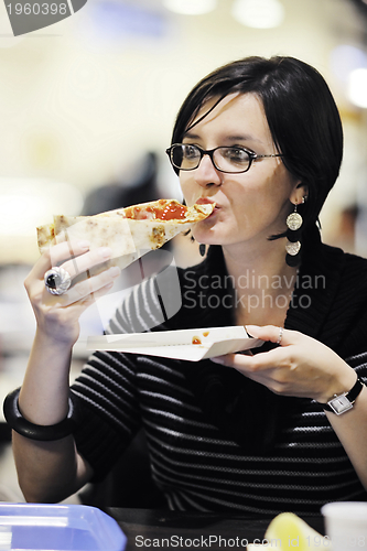 Image of woman eat pizza food at restaurant