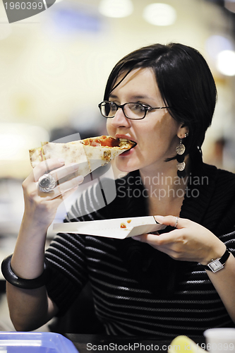 Image of woman eat pizza food at restaurant