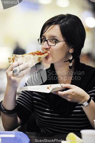 Image of woman eat pizza food at restaurant