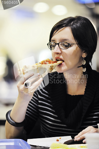 Image of woman eat pizza food at restaurant