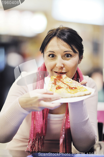 Image of woman eat pizza food at restaurant