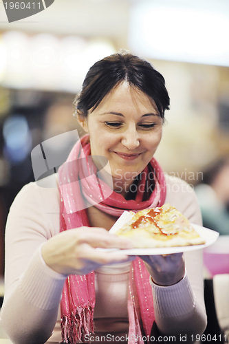 Image of woman eat pizza food at restaurant