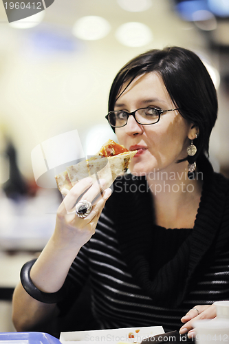 Image of woman eat pizza food at restaurant