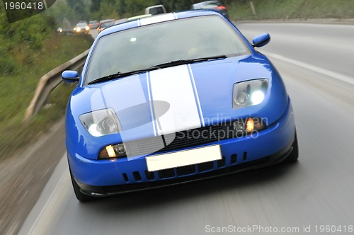 Image of Tuning cars sacing down the highway