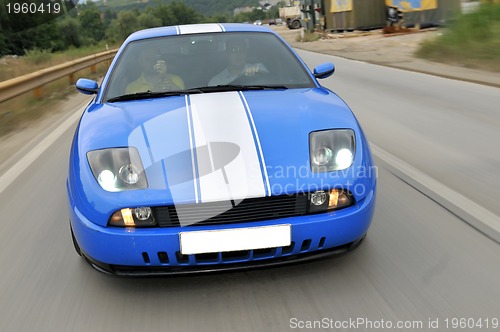 Image of Tuning cars sacing down the highway