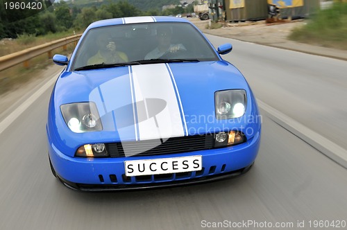 Image of Tuning cars sacing down the highway