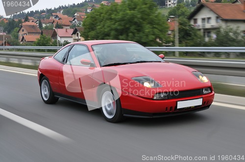 Image of Tuning cars sacing down the highway