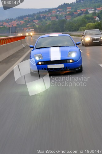 Image of Tuning cars sacing down the highway