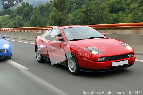 Image of Tuning cars sacing down the highway