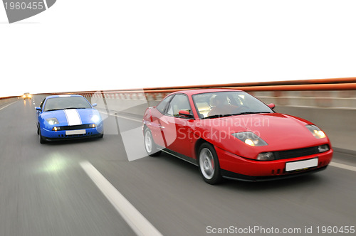 Image of Tuning cars sacing down the highway