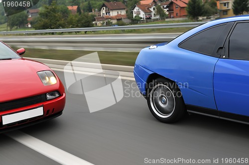 Image of Tuning cars sacing down the highway