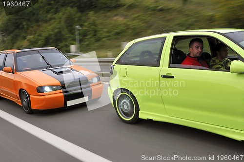 Image of Tuning cars sacing down the highway