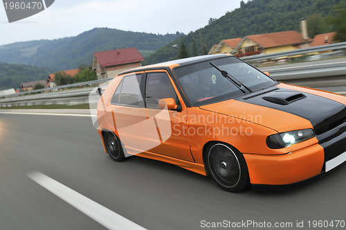 Image of Tuning cars sacing down the highway