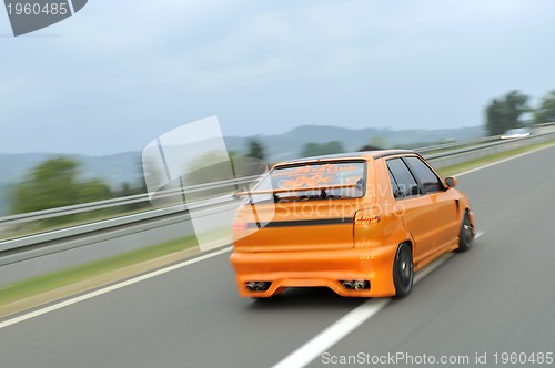 Image of Tuning cars sacing down the highway