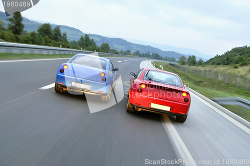 Image of Tuning cars sacing down the highway