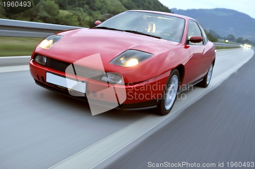 Image of Tuning cars sacing down the highway