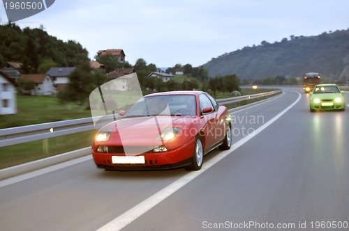 Image of Tuning cars sacing down the highway