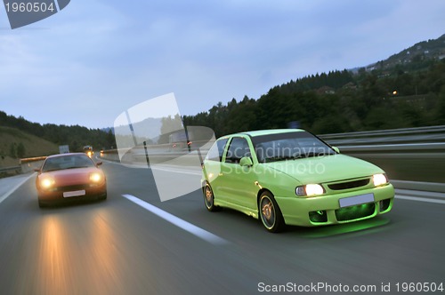 Image of Tuning cars sacing down the highway