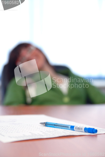 Image of young businesswoman signing a contract 