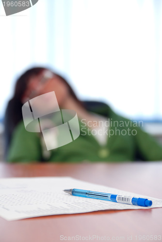 Image of young businesswoman signing a contract 