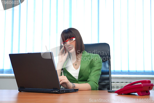 Image of .young businesswoman working on a laptop computer in the office.