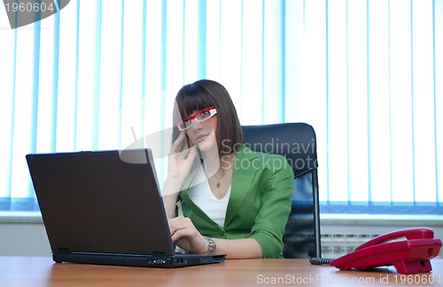 Image of .young businesswoman working on a laptop computer in the office.