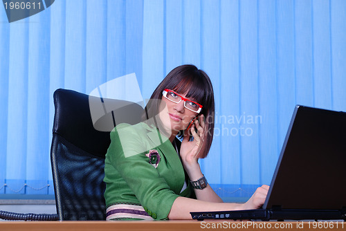 Image of .young businesswoman working on a laptop computer in the office.