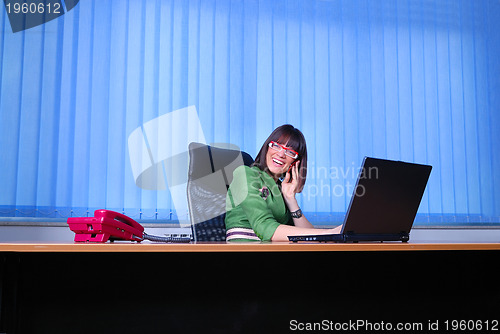 Image of .young businesswoman working on a laptop computer in the office.